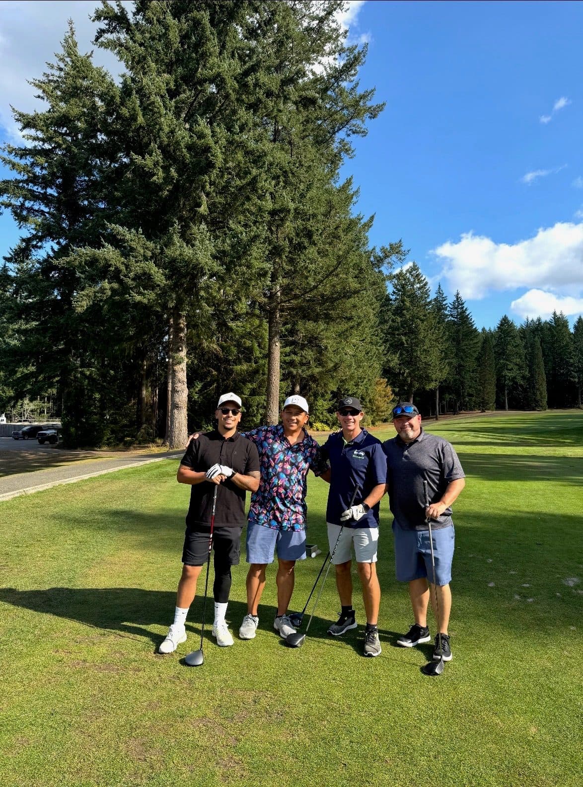 Golf group standing together on a Pacific Northwest course