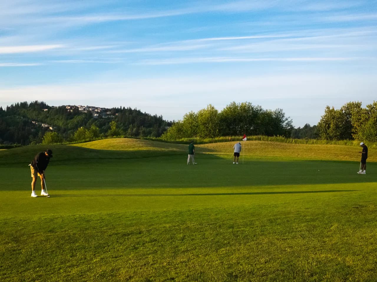 Players putting on a wide green during a relaxed 18 Holes to Home round
